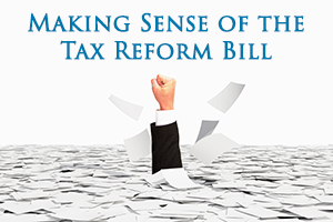 Hand punching through papers with text that says, "Making Sense of the Tax Reform Bill"